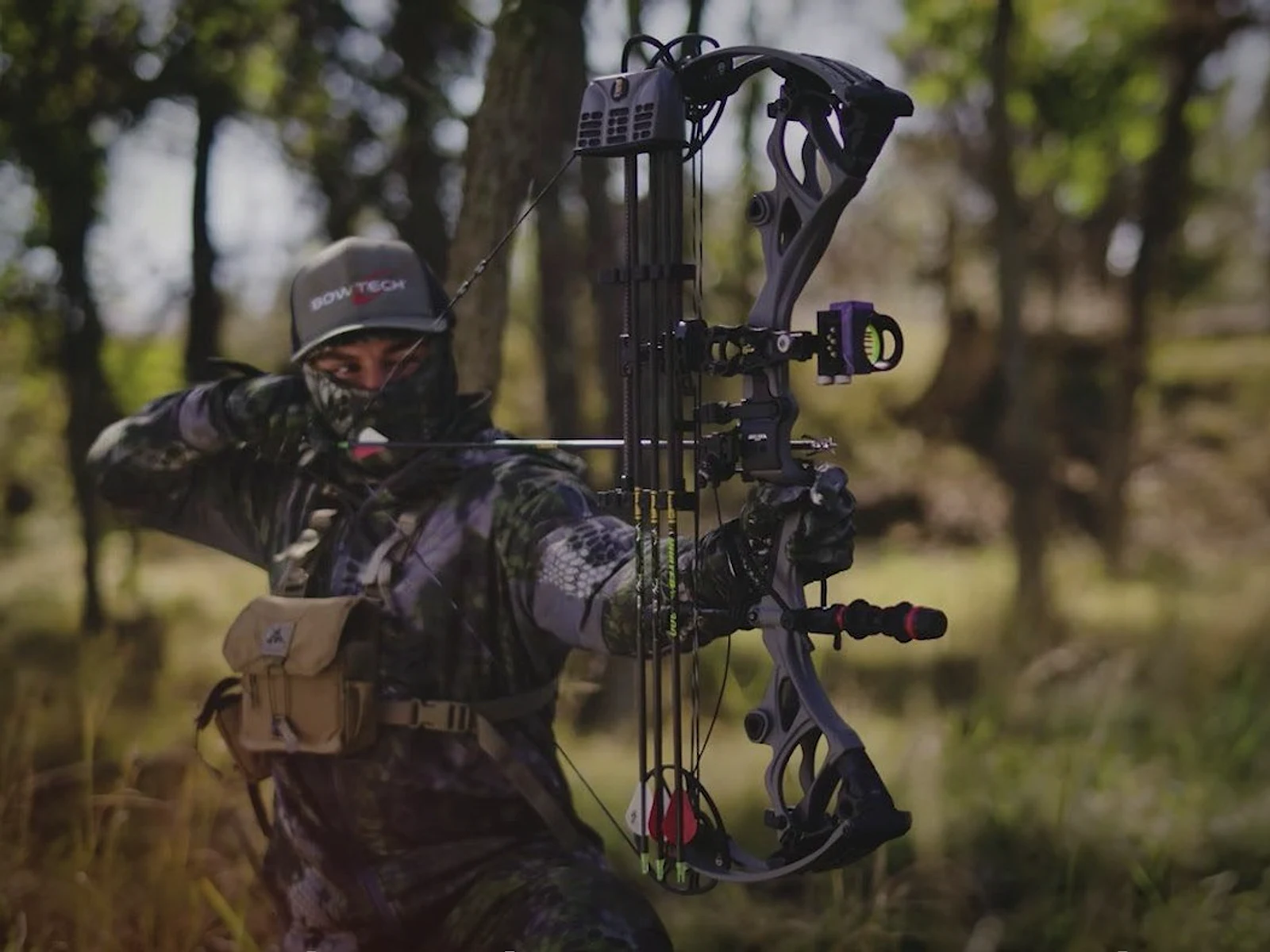Bowhunter holding a compound bow in the field