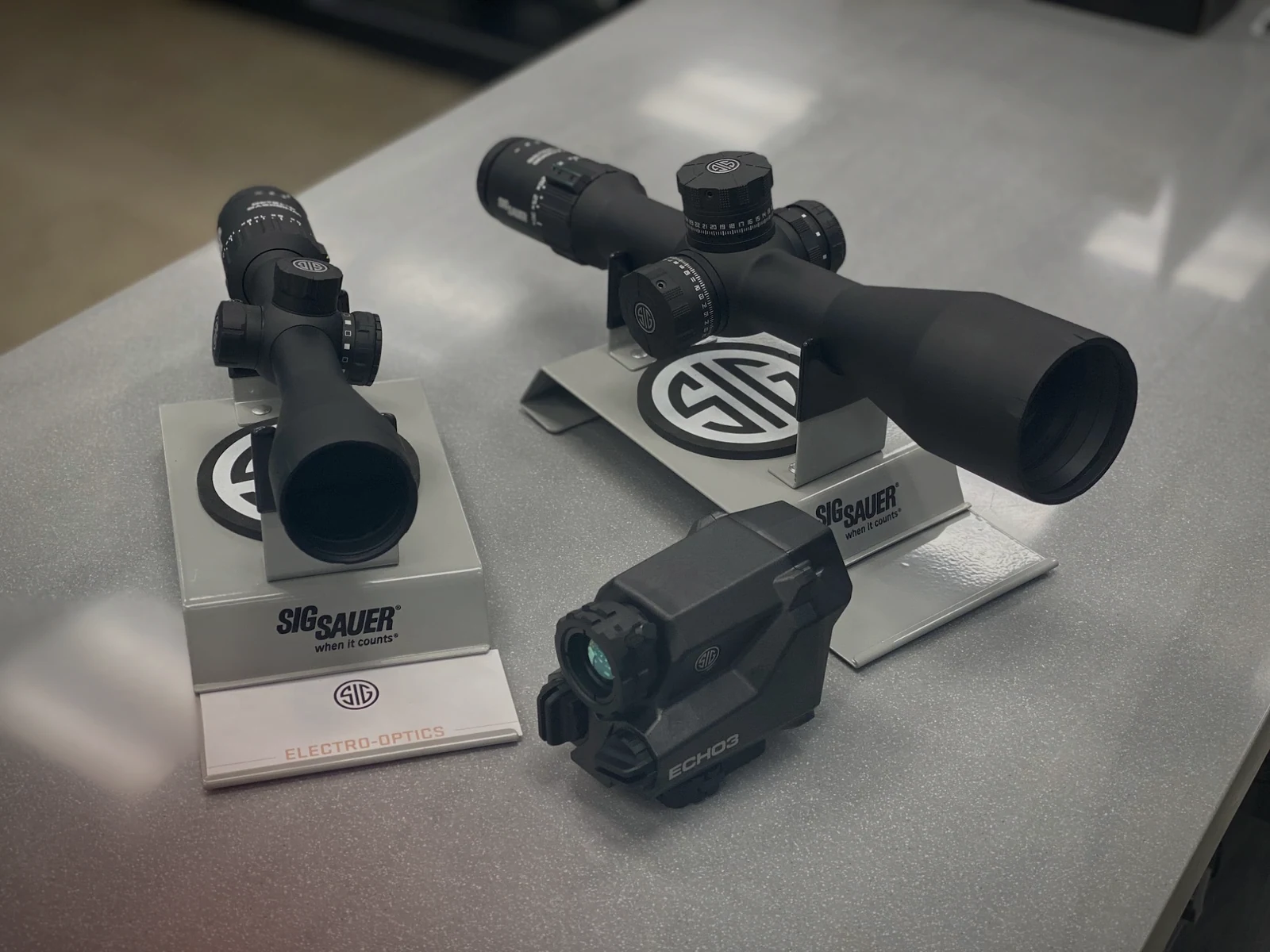 SIG Sauer riflescopes and electronic optic displayed together