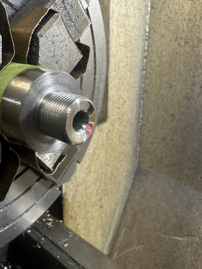 Close-up of a threaded muzzle in the lathe