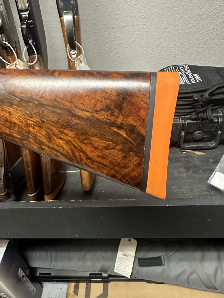 Wood-stock firearm with a fitted recoil pad